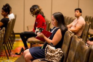 Girl taking notes at a 2018 USCA Panel